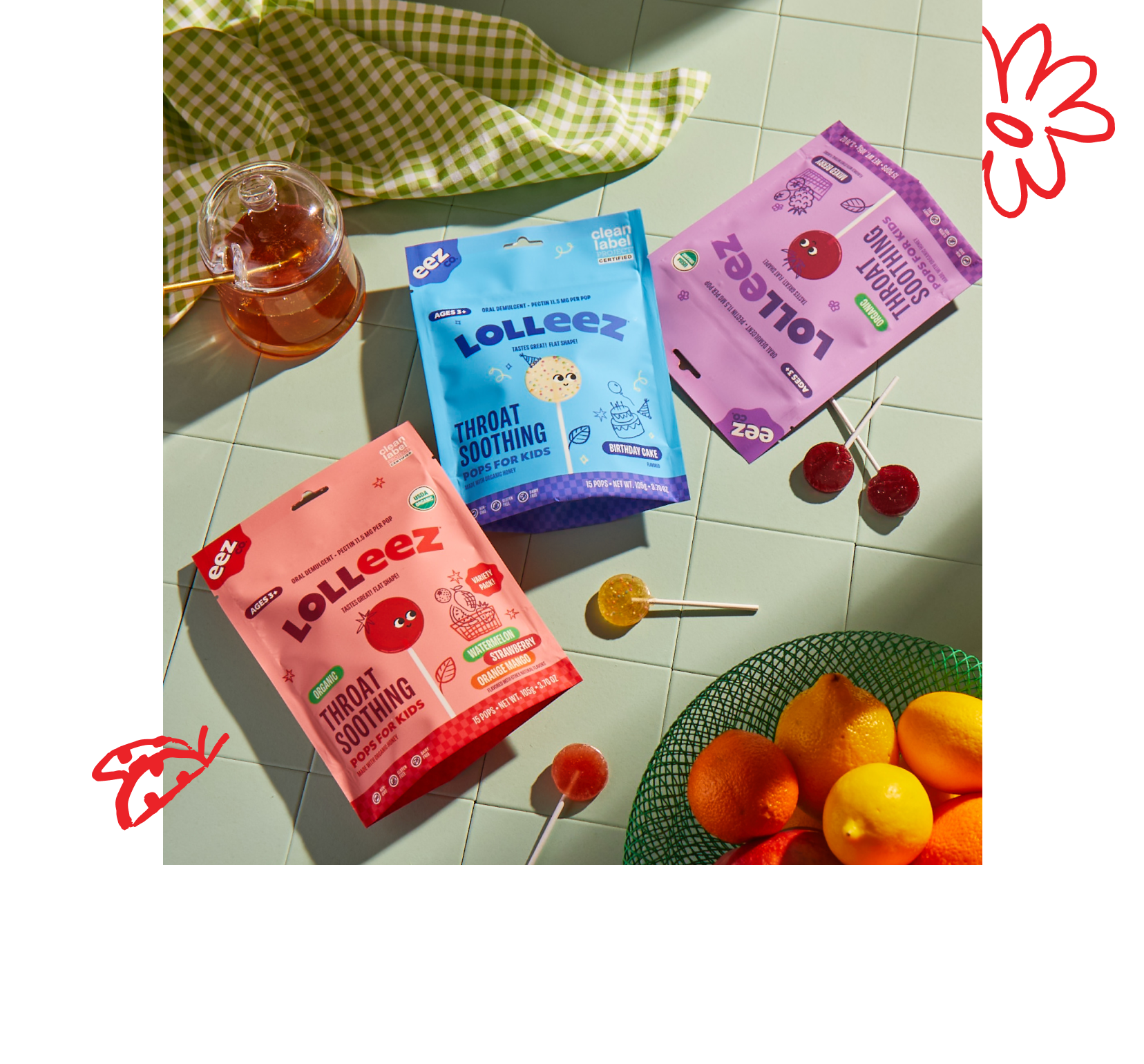 Lolleez packaging on a kitchen countertop with loose pops displayed next to a fruit bowl
